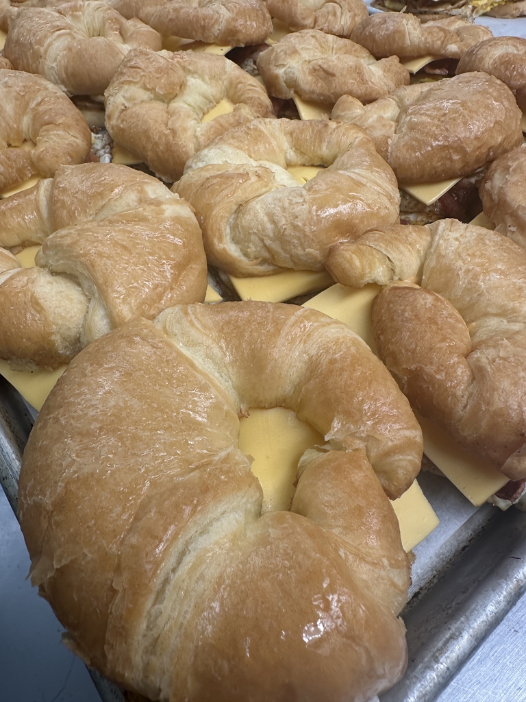 Tray of freshly prepared bacon, egg, and cheese croissant sandwiches at Appalachia Provisions Café.