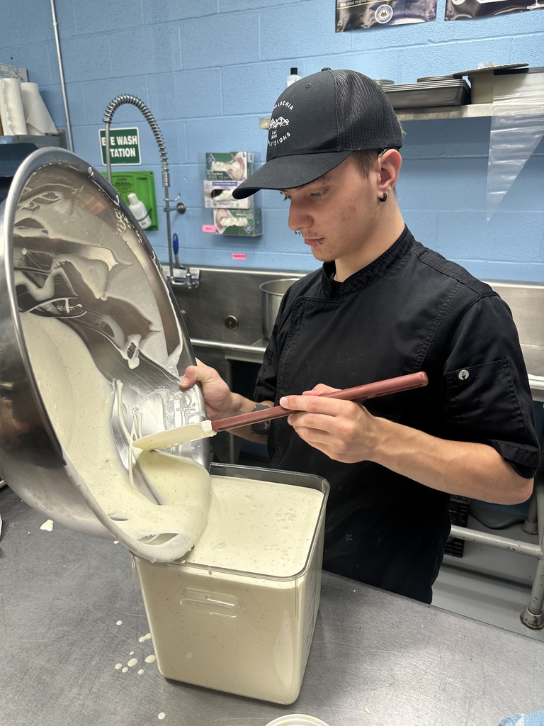 Appalachia Provisions student transfers a freshly mixed café recipe into a food storage container.