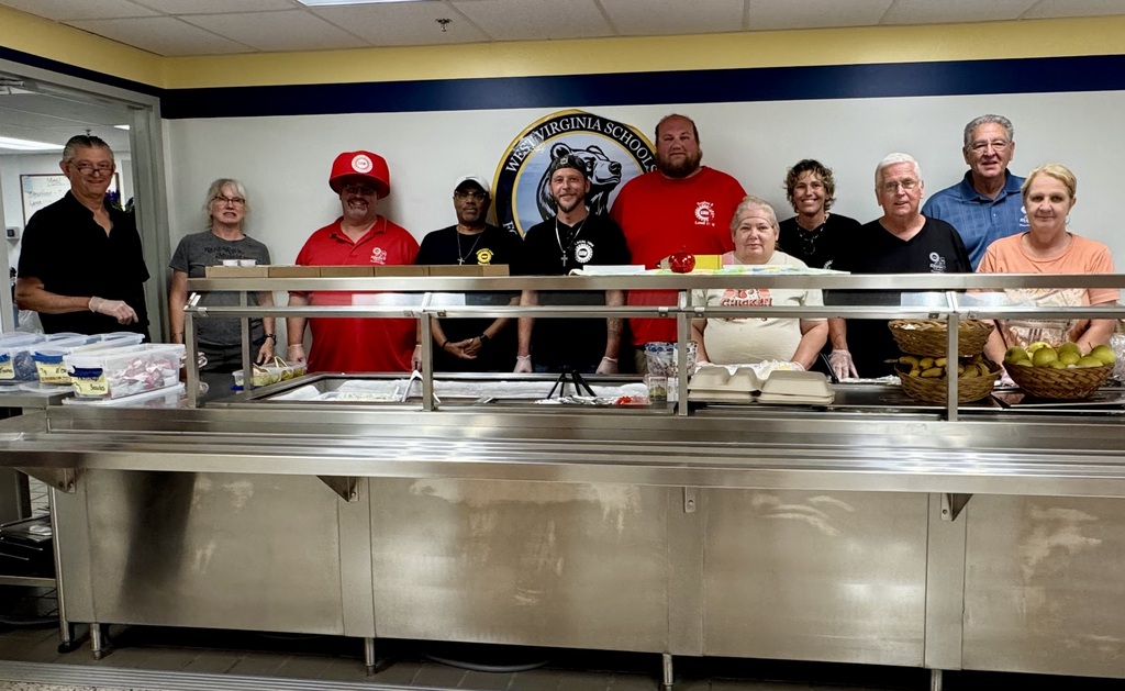 Members of UAW Local #1590 stand behind the cafeteria serving line at WVSDB during the annual picnic.