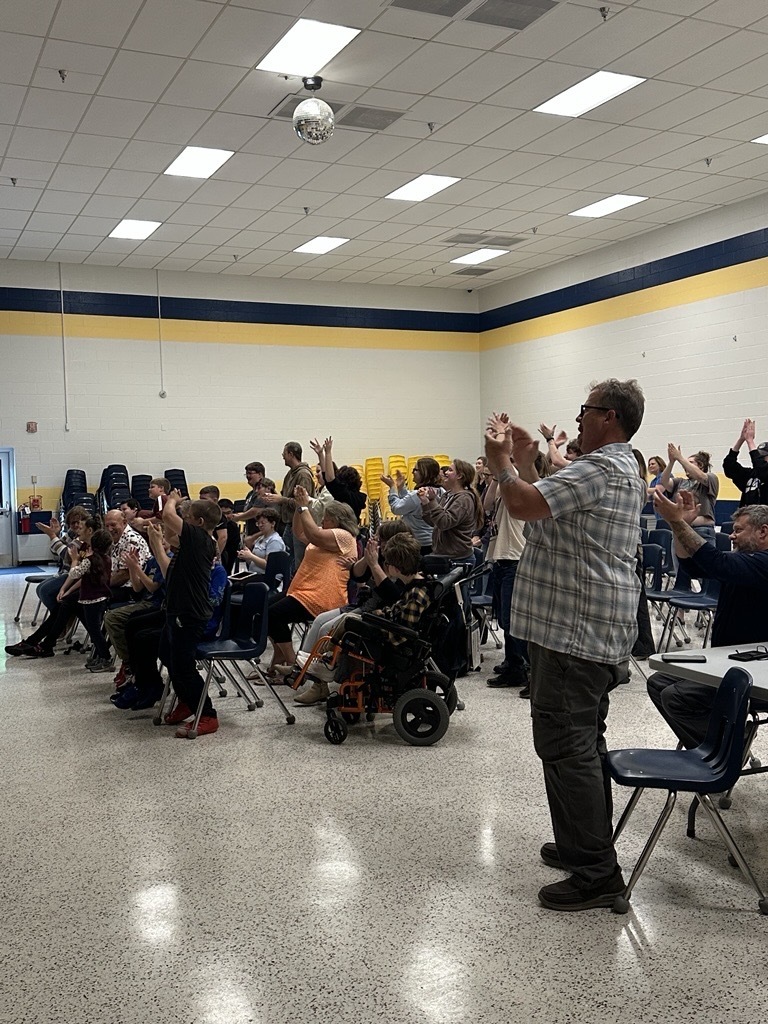 WVSDB students and staff participate from the audience, raising their hands and following along with the performance.