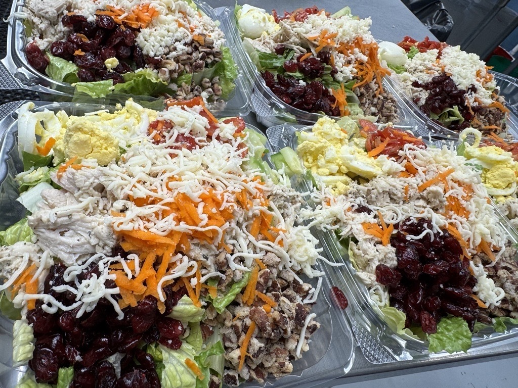 Freshly prepared chicken salads topped with cranberries, pecans, shredded carrots, cheese and other ingredients at Appalachia Provisions.