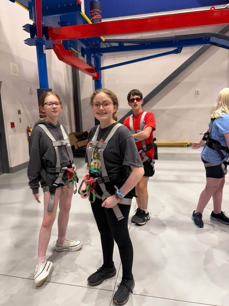 Students wearing safety harnesses prepare for a hands-on challenge during SCIVIS Space Camp.