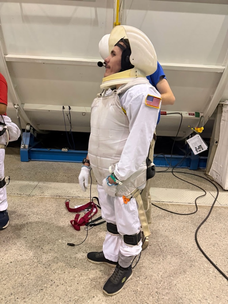 WVSDB student dressed in astronaut training gear, including a white suit and helmet, prepares for a simulated space mission.