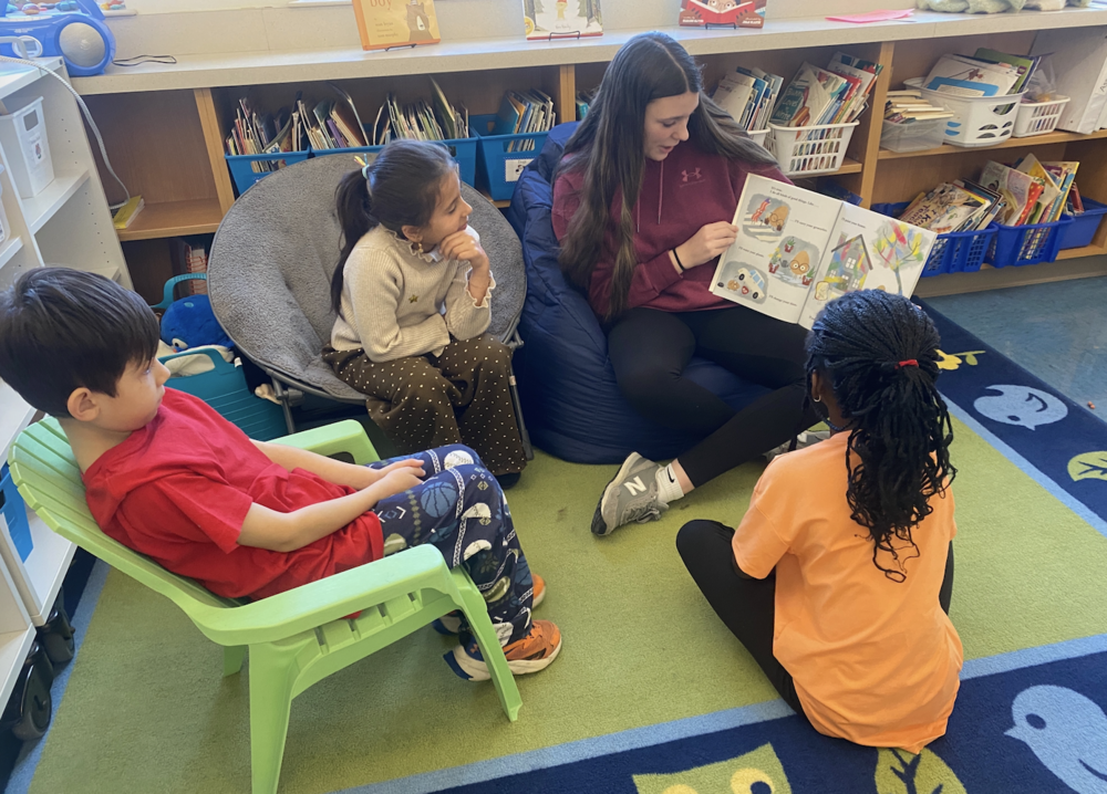 High school student reading to students