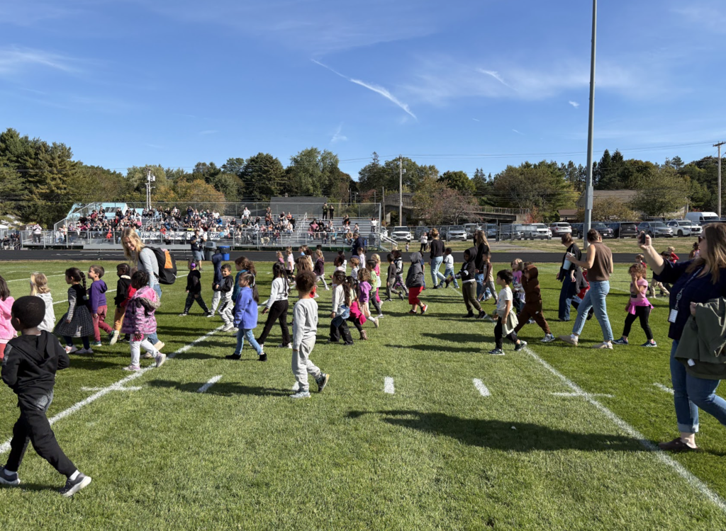 kids walking across field