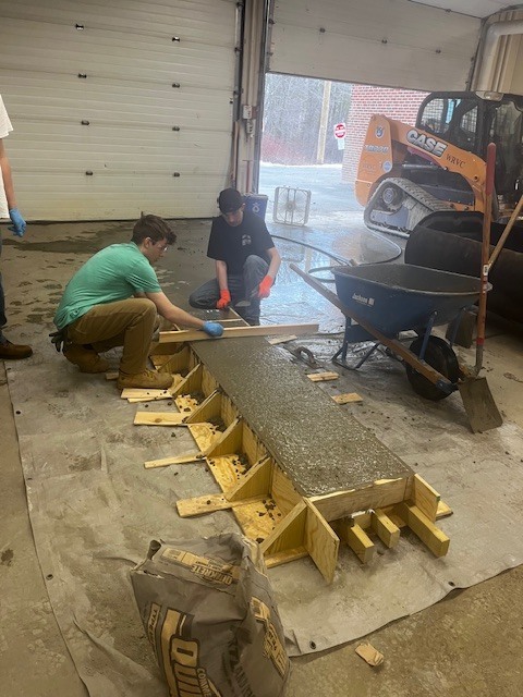 HEO creating a concrete bench