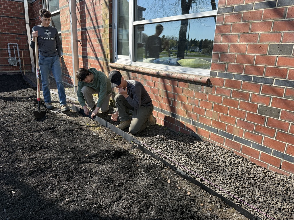 HEO students installing edging for the stone drip-edge