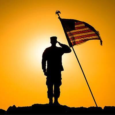 image of a american solider with an american flag as the sun risers