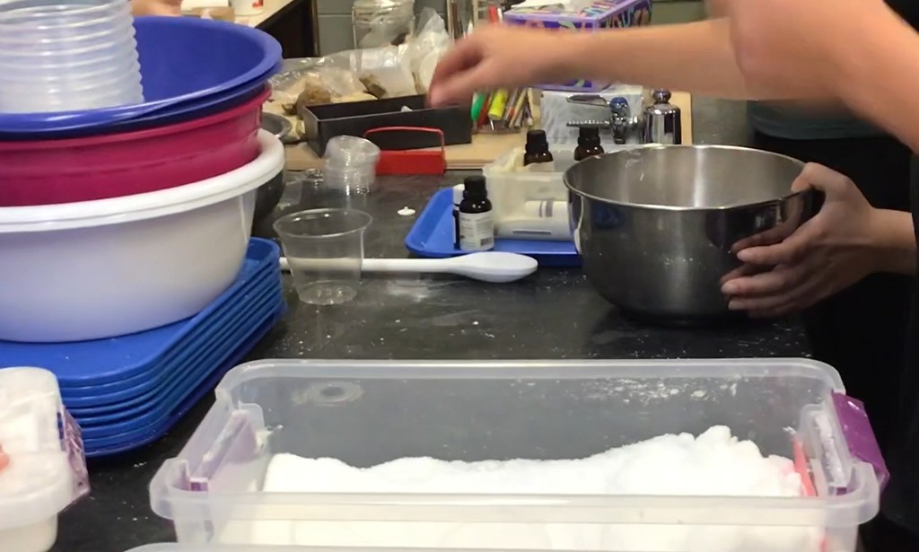 8th graders making bath bombs in science class