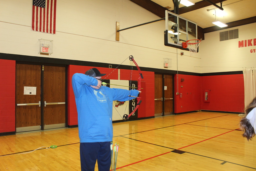 PE is learing about archery with Coack K. 