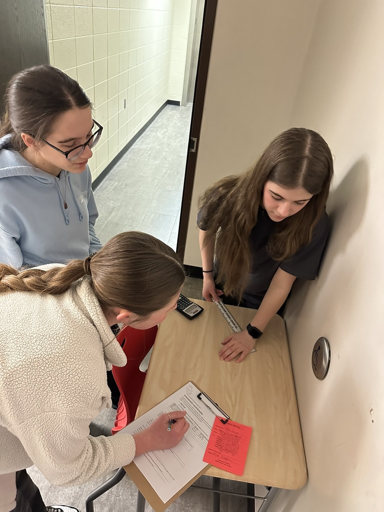 7th & 8th graders doing a "Pi Day" scavenger hunt