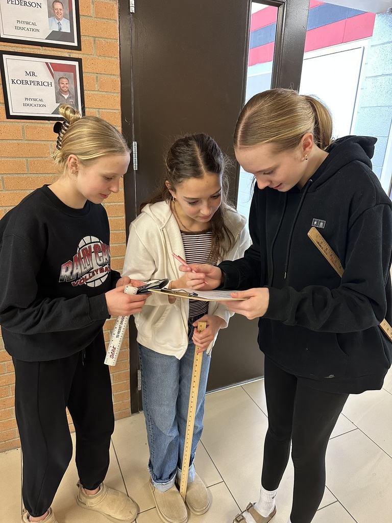 7th & 8th graders doing a "Pi Day" scavenger hunt