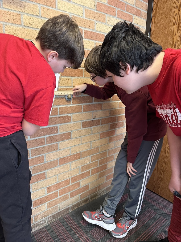 7th & 8th graders doing a "Pi Day" scavenger hunt