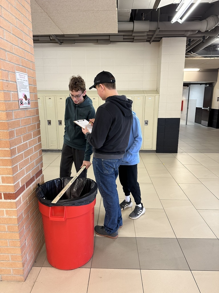 7th & 8th graders doing a "Pi Day" scavenger hunt
