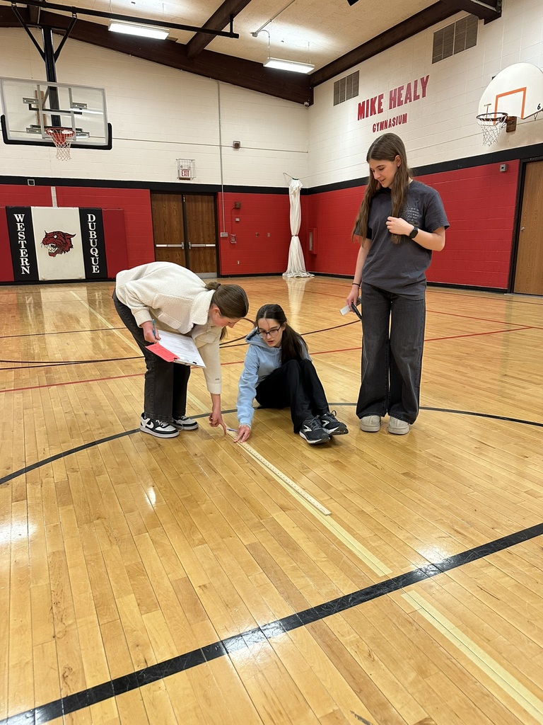 7th & 8th graders doing a "Pi Day" scavenger hunt