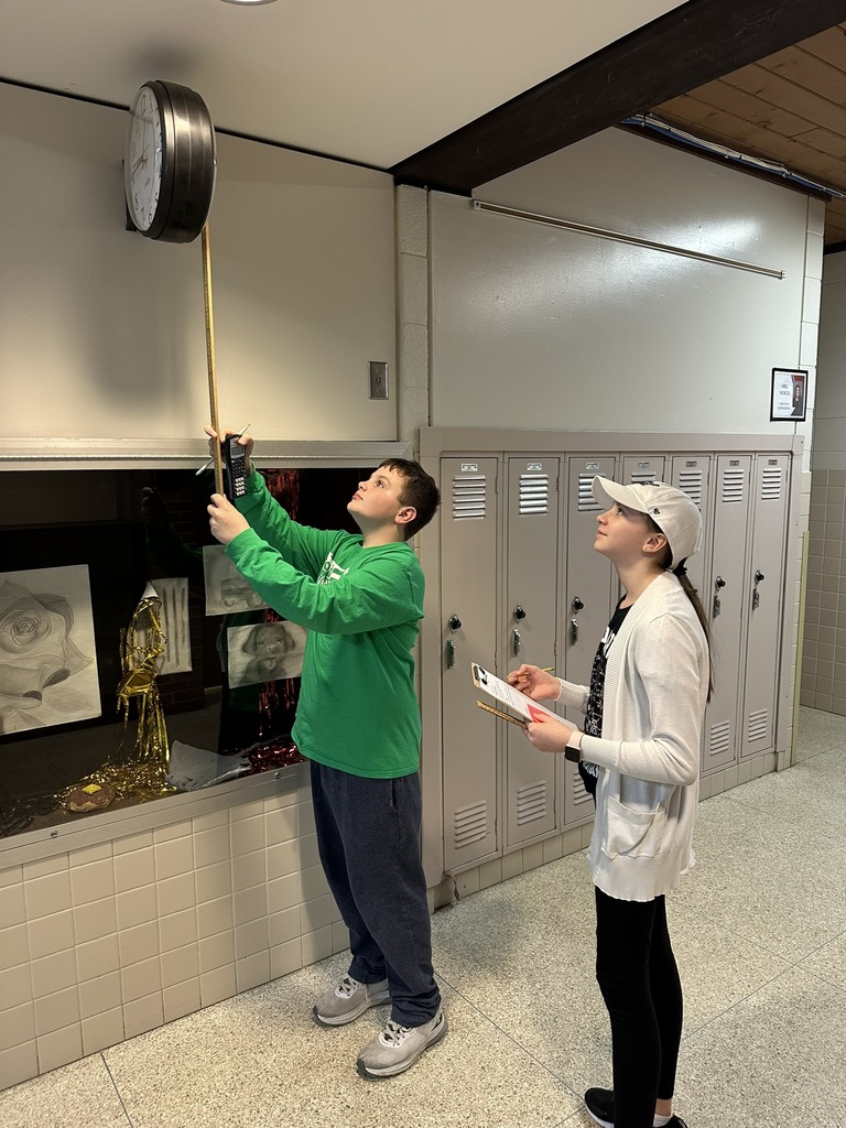 7th & 8th graders doing a "Pi Day" scavenger hunt