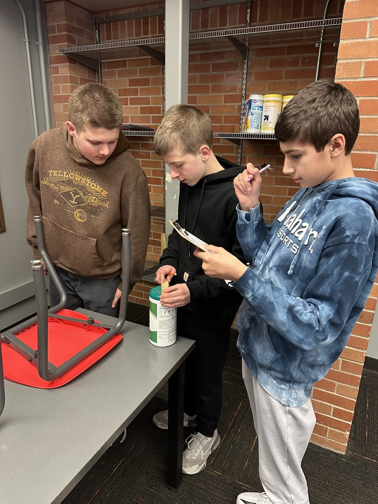 7th & 8th graders doing a "Pi Day" scavenger hunt