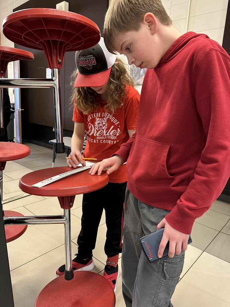 7th & 8th graders doing a "Pi Day" scavenger hunt