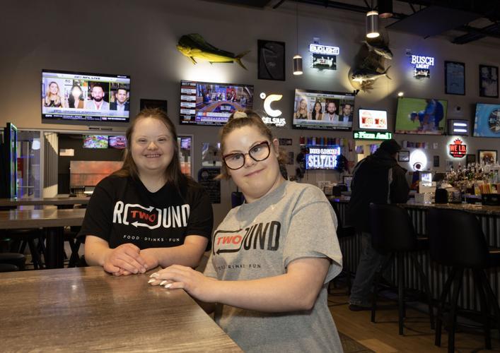 Two people posing for a picture at a restaurant