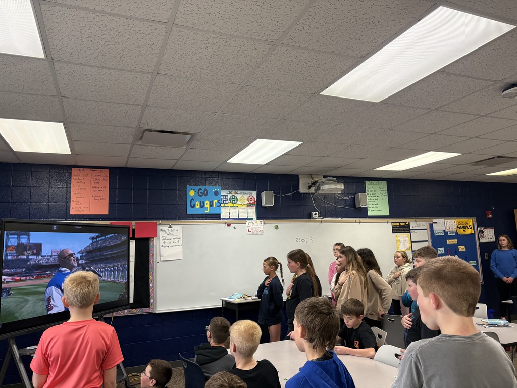 Students watching baseball on TV.