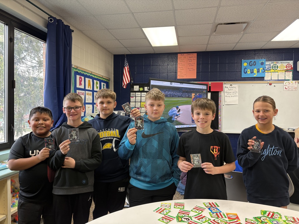 Students holding baseball cards.