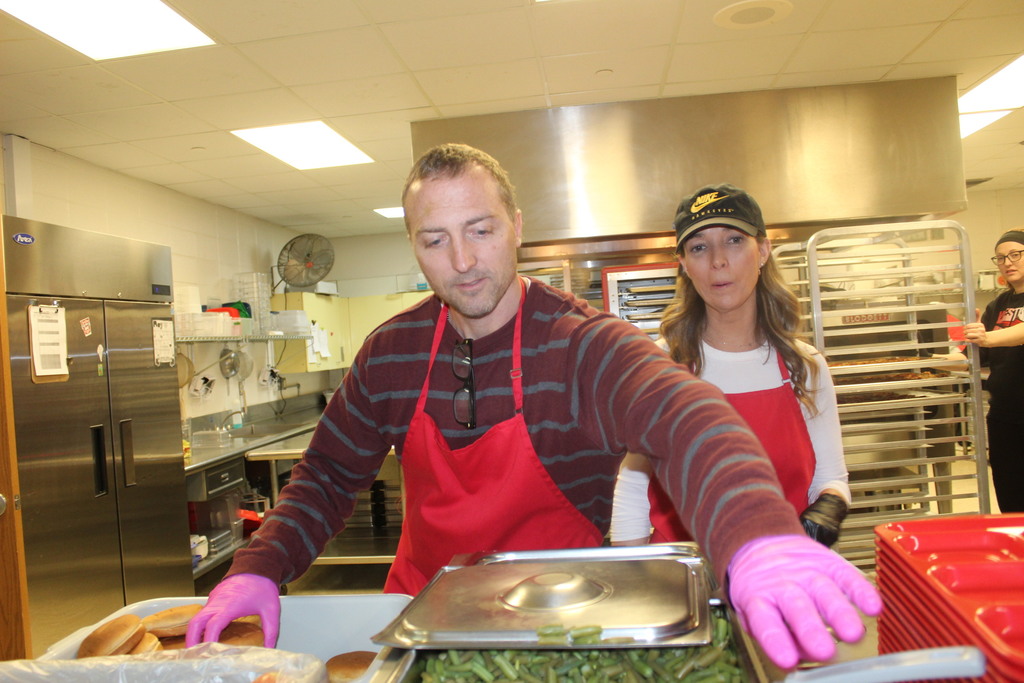 Mr. Hatcher & Mrs. Goldsmith  serving up lunches to give the kitchen staff a break on "School Lunch Hero Day"!