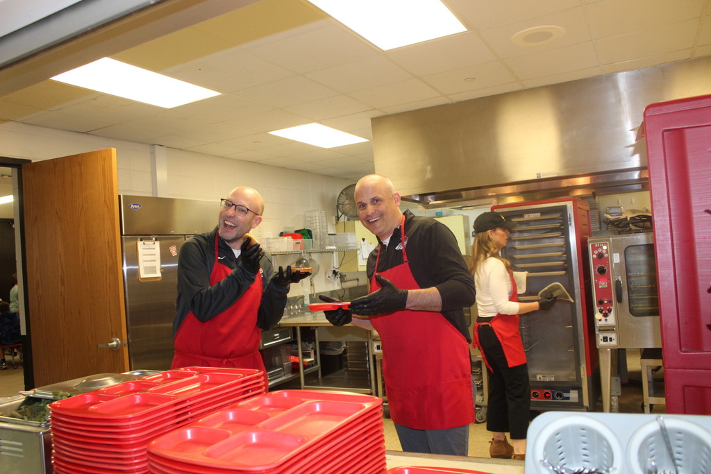 Mr. Kedley & Mr. Wernimont serving up lunches to give the kitchen staff a break on "School Lunch Hero Day"!