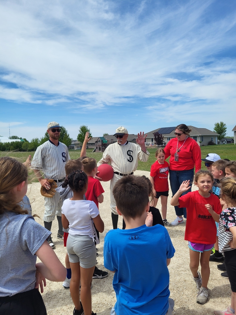 Group photo of students listening to adults explain the game