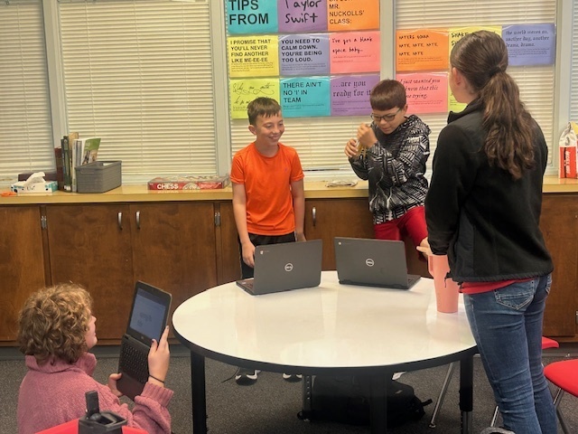 Students working as a group to plan their skit.