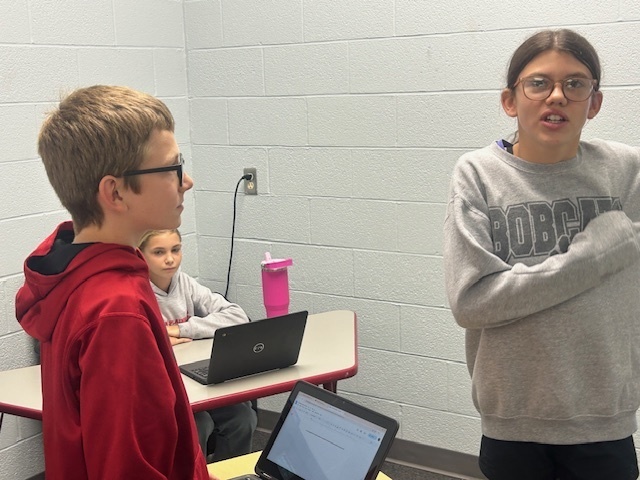 Students working as a group to plan their skit.