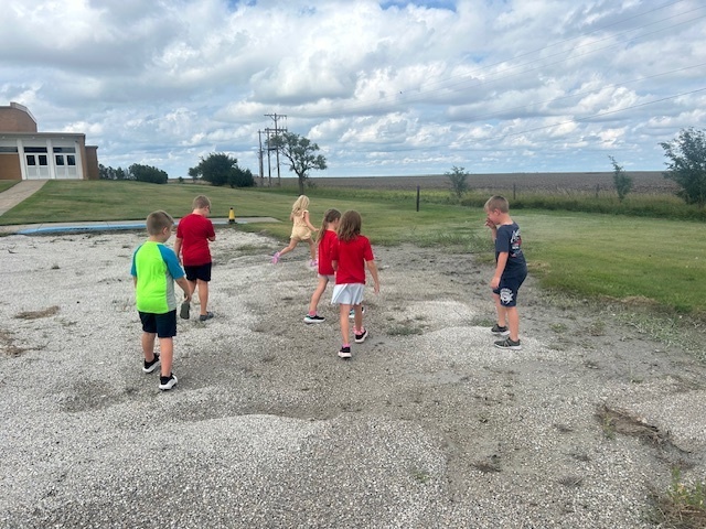 Students looking at ways wind and water have moved land around the school.