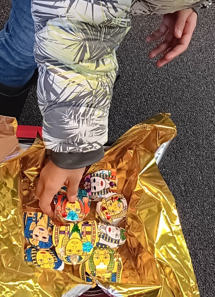 Placing apple mummies into the sarcophagus