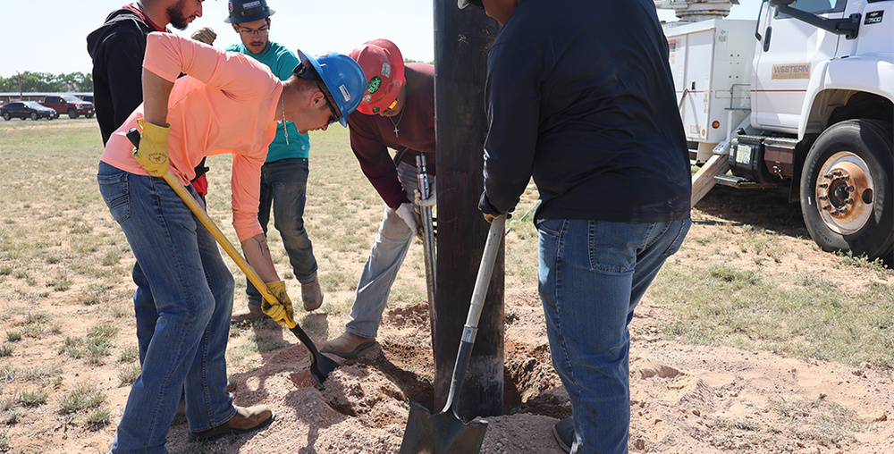 WTC Electrical Lineworker students ready poles for installation