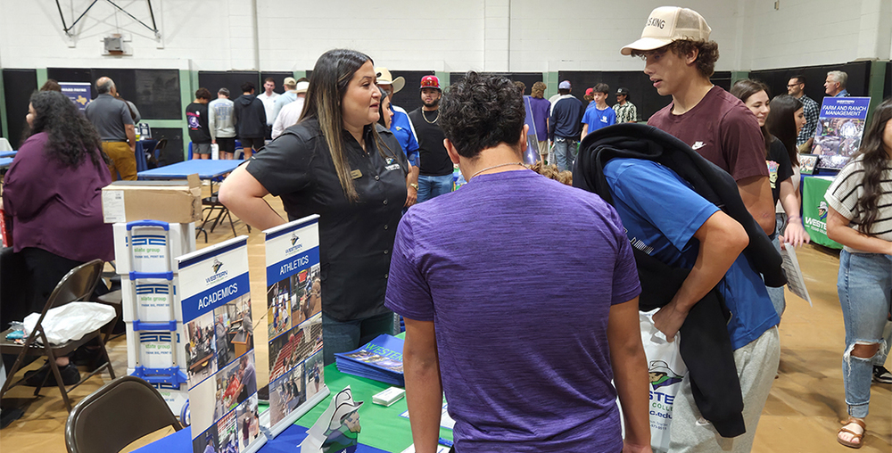Isrell Lawson, WTC’s Welcome Center and Enrollment Outreach Director, speaks with prospective students at the 2025 Western Texas College Fair.
