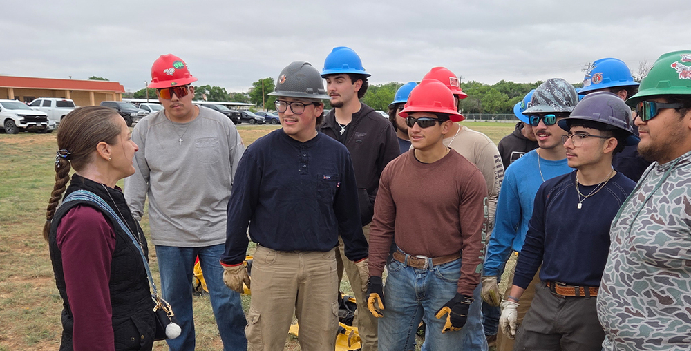 WTC President Dr. Laurie Sharp speaks with students at the Electrical Lineworker Rodeo in the spring of 2026.