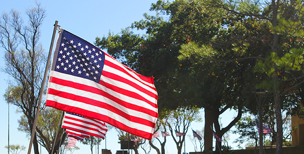 A row of American flags wave in the breeze in front of the Scurry County Museum on the Western Texas College campus.