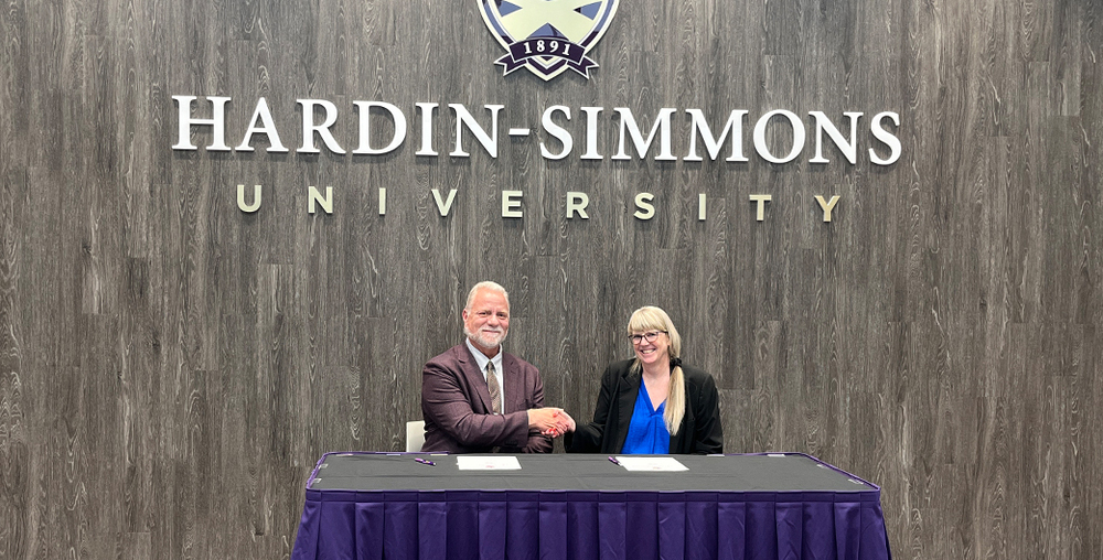 : Dr. Christopher McNair, Hardin-Simmons Provost & Chief Academic Officer, shakes hands with Stephanie Ducheneaux, Western Texas College Vice President for Academic Affairs.