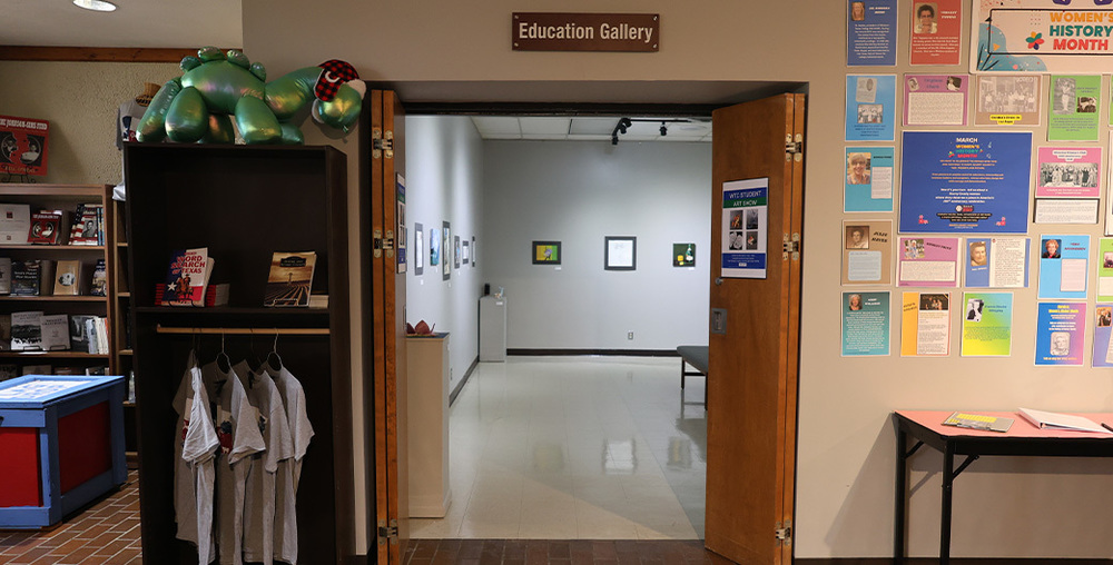 A view of studnet artwork through the doorway to the Education Gallery in the Scurry County Museum.