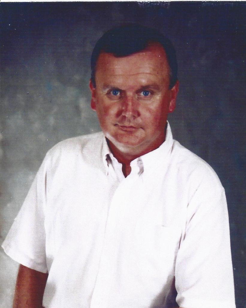 A photo of Terry Don McDowell in a short sleeve, white button-up shirt.