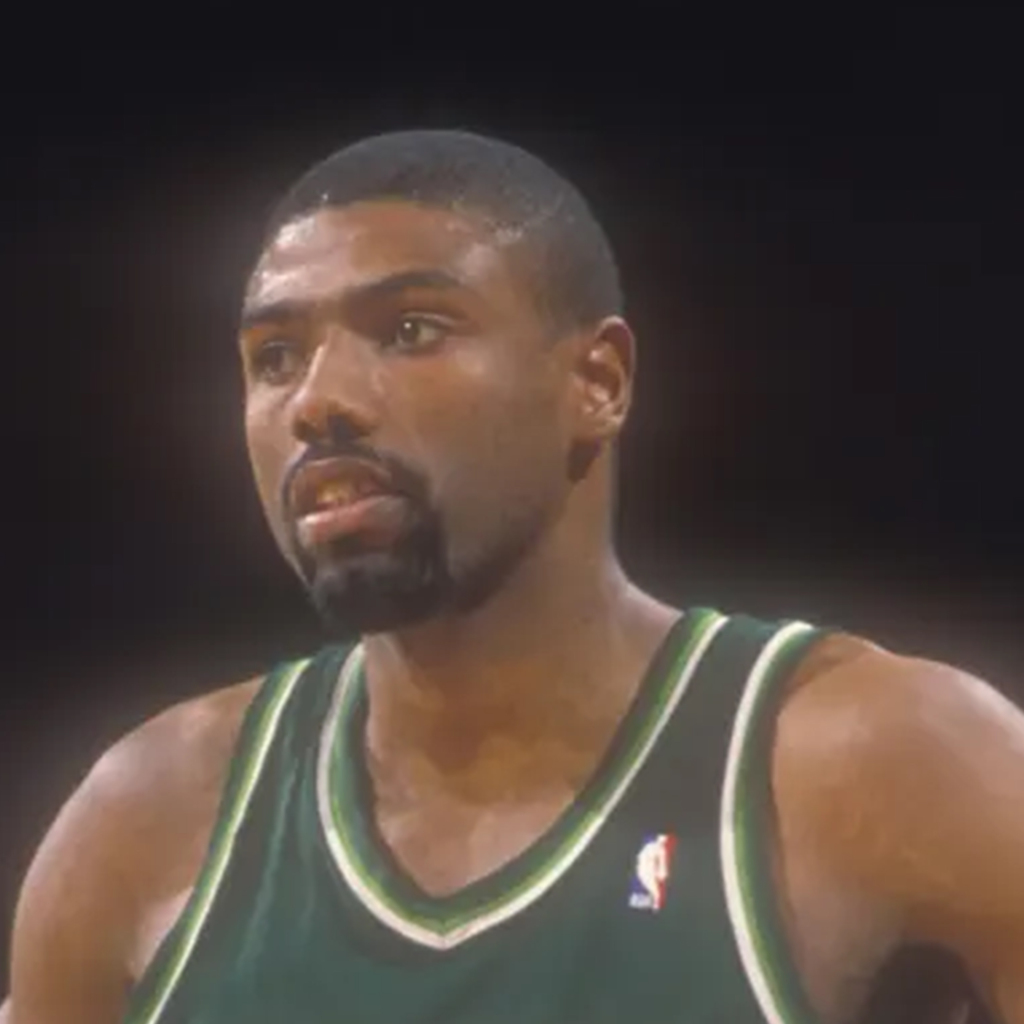 Paul Pressey looks down the court during a 1980's basketball game.