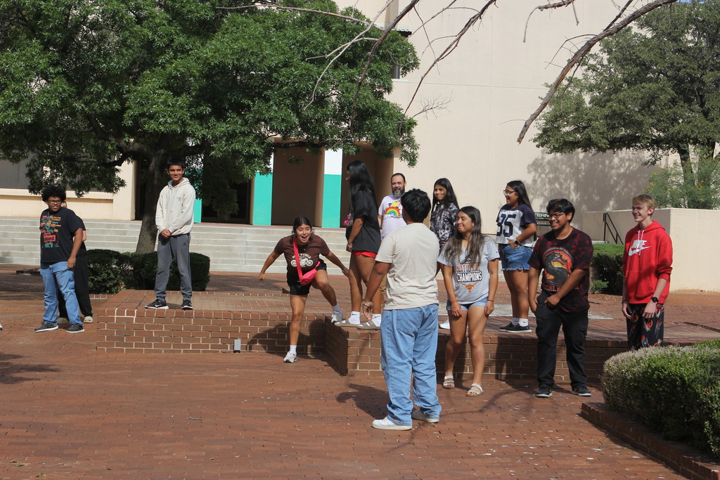 Upward Bound students laugh and smile while playing a game of "Statue."