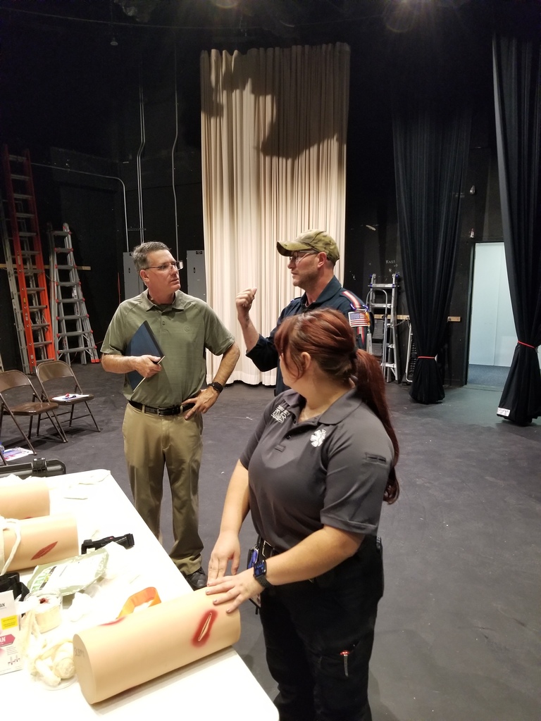 Shawn speaks with Jason G. and Zowie at the Stop the Bleed table.