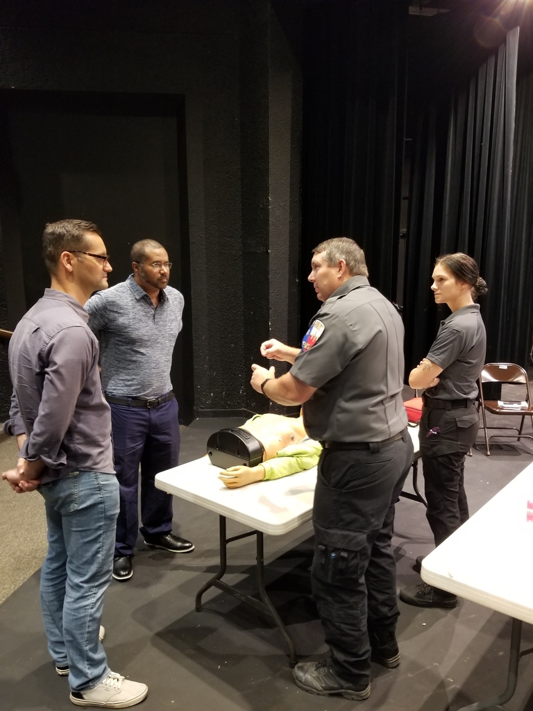 Jason explains a technique while staff members look on.