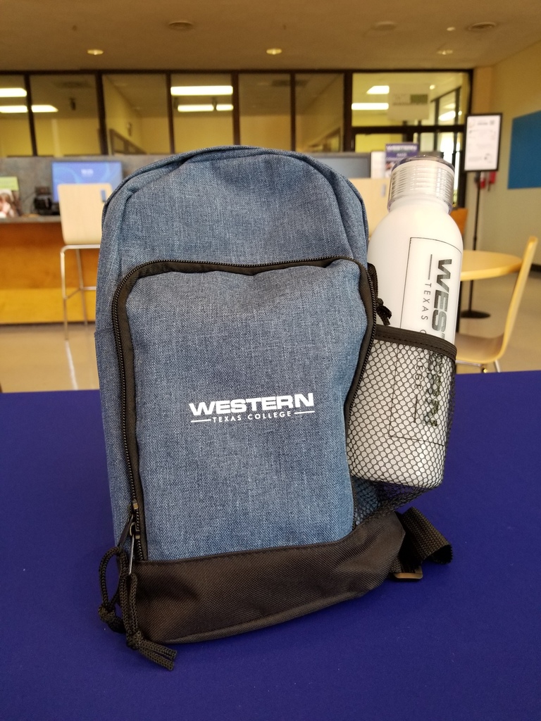 A blue/gray sling pack with a WTC water bottle in the side net pocket.