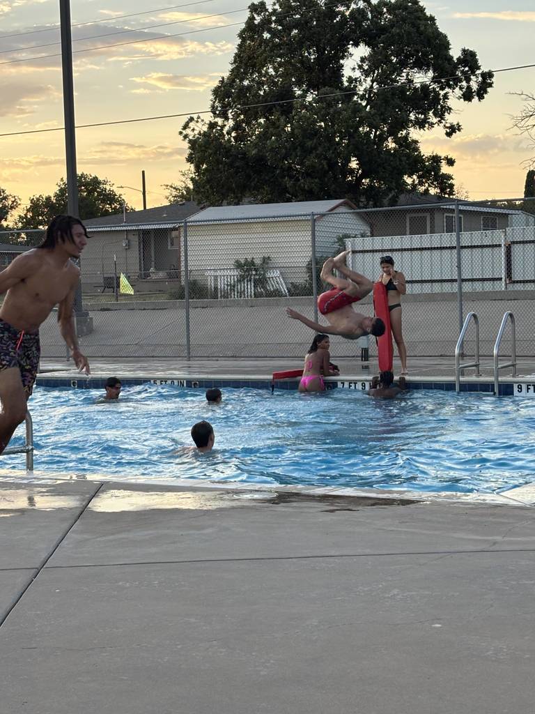 A student flips off the diving board.