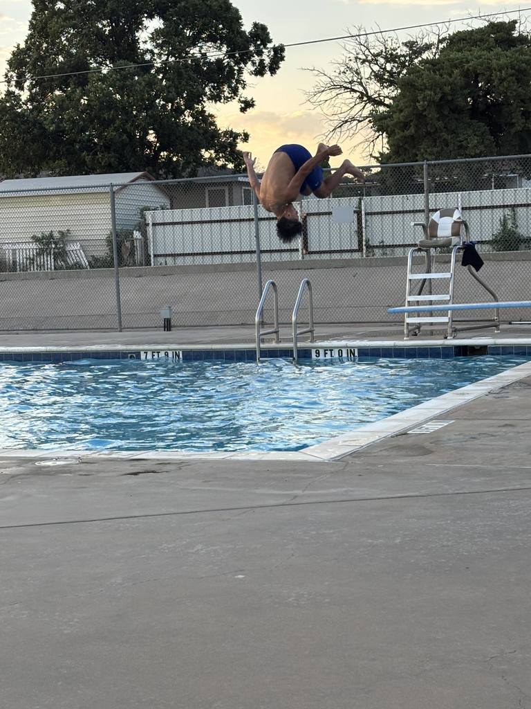 A student flips off the diving board.