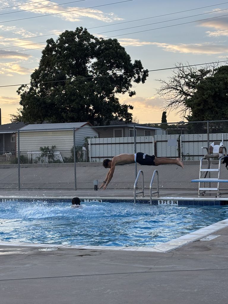 A student dives off the diving board.