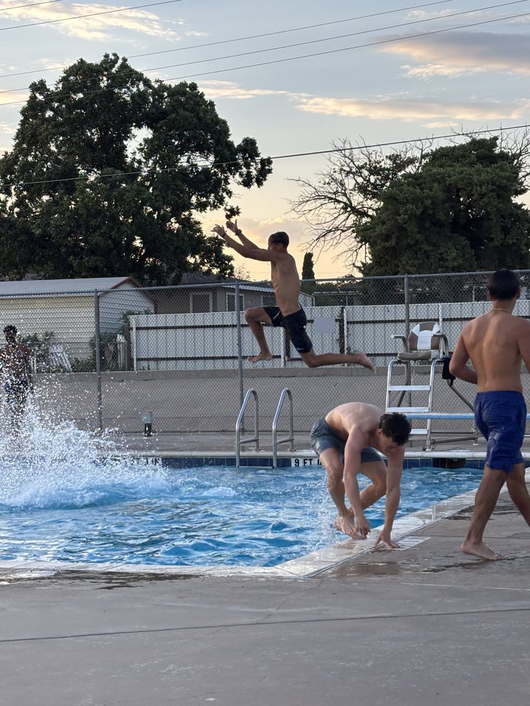 A student jumps off the diving board.