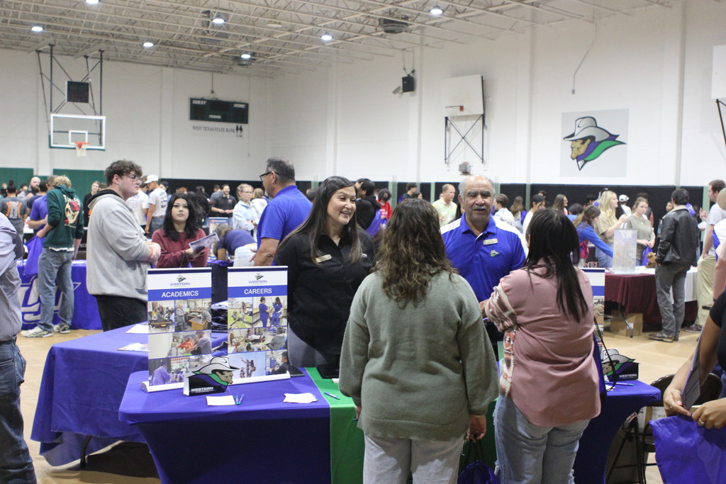 Western Texas College recruiters Isrell Lawson and Raúl Alcalá speak with prospective students at the 2024 College Fair