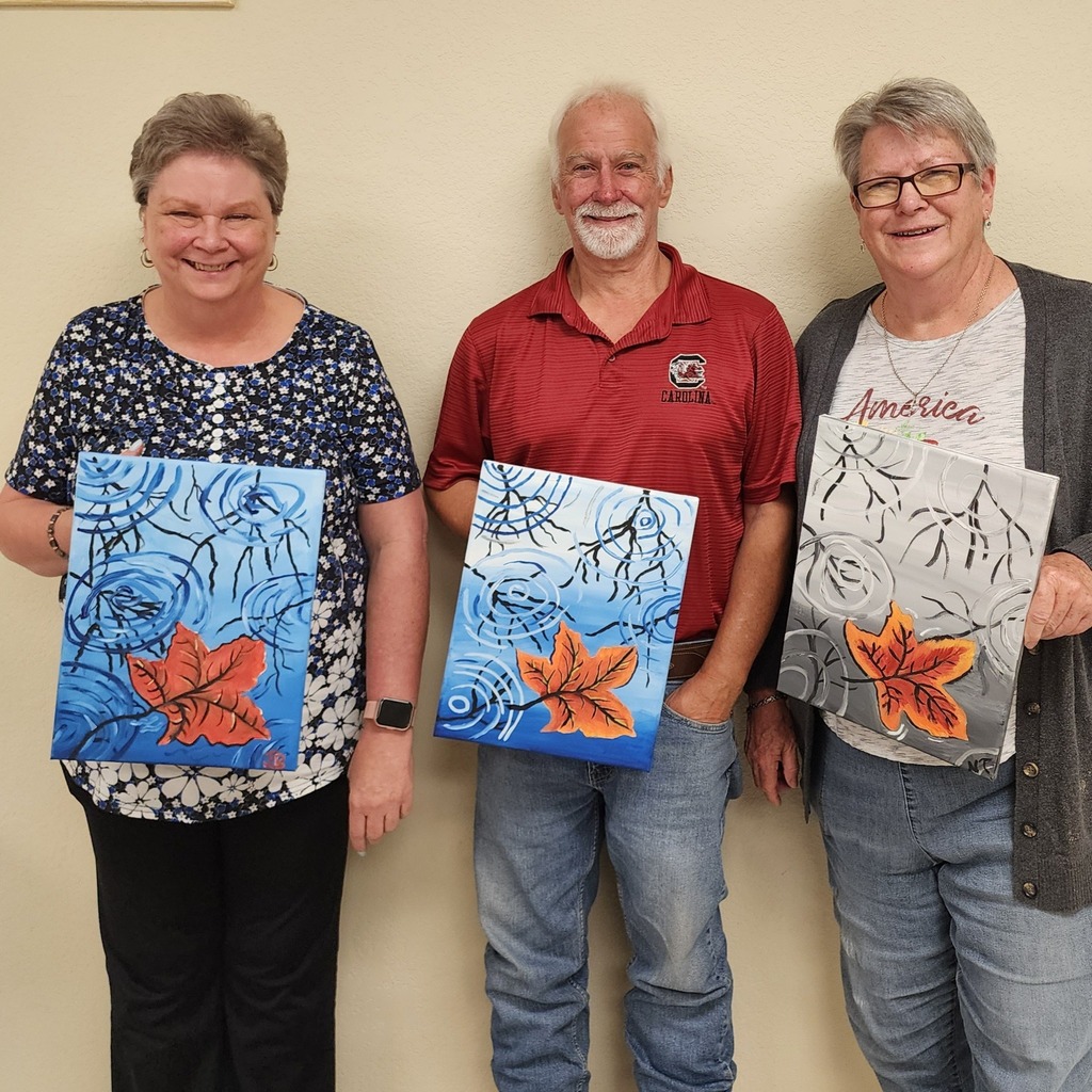 Art students holding artwork